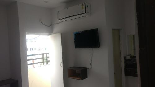 a room with a flat screen tv on a wall at Durga Pride in Kurnool
