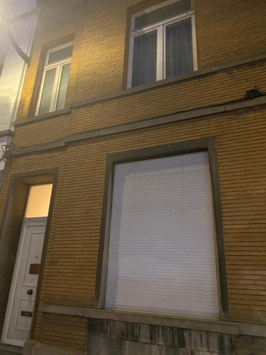 a building with a large white garage door at Brussels Guesthouse - Private bedroom and bathroom in Brussels