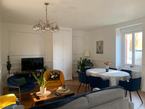 un salon avec un canapé et une table dans l'établissement Maison année 30 chic et cosy, à Lorient