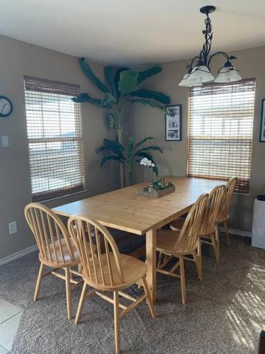 a dining room with a wooden table and chairs at The Aloha Beach in Surfside Beach