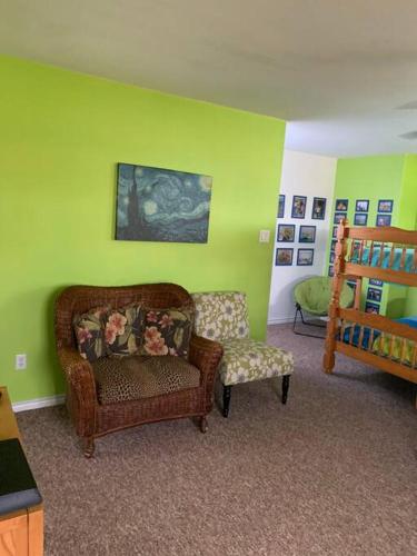 a living room with a couch and a chair at The Aloha Beach in Surfside Beach