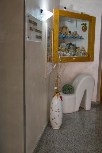 a corner of a room with a vase and a sink at Hotel San Marco in Rionero in Vulture