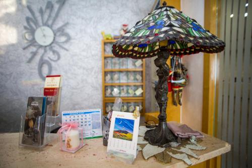 a table with a lamp on top of a table at Hotel San Marco in Rionero in Vulture