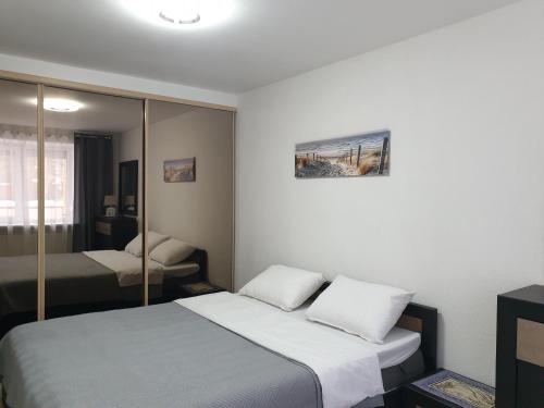 a bedroom with a bed and a mirror at Mano jūra in Palanga