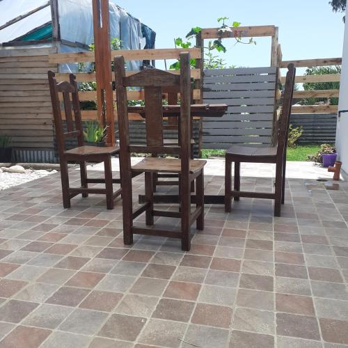 a wooden table and two chairs on a patio at Las Aves in Mar del Plata