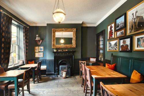 a restaurant with wooden tables and a fireplace at The Fat Badger in York