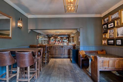 a restaurant with wooden tables and a bar at The Fat Badger in York