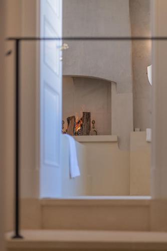 a glass window in a room with a fireplace at Palazzo Matteo in Nardò