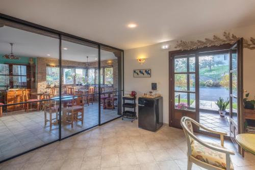 a living room with a table and chairs and a dining room at Hotel Rural Porrua in Porrúa