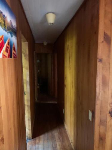 an empty hallway with wood walls and a ceiling at Cabañas pucon in Pucón