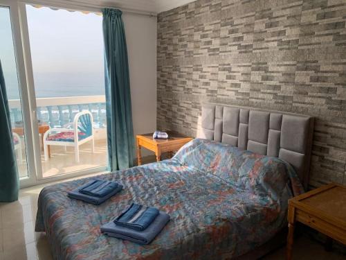 a bedroom with a bed with two towels on it at Taghazout waves 2 in Taghazout