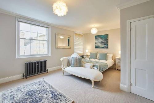 a room with a bed and a couch and a chair at Deja Blue Beautiful period property in Whitby