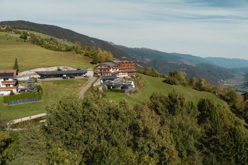 an aerial view of a house on a hill at Panoramahotel Huberhof in Maranza