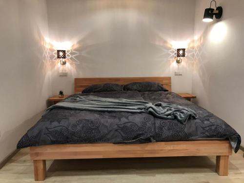 a bedroom with a bed with two lights on the wall at Loft - Luxus Apartment zum Wohlfühlen im Allgäu in Marktoberdorf