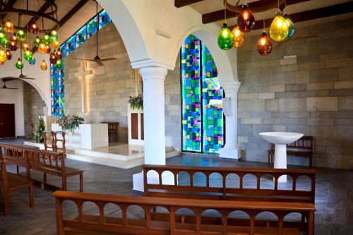 a church with benches and stained glass windows at Bahia Principe Grand Tulum - All Inclusive in Akumal