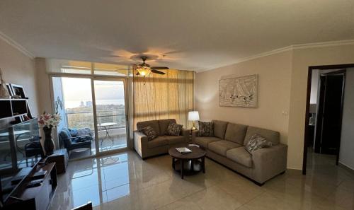 a living room with a couch and a table at Amazing Ocean View Luxury Condo in Coronado Panama in Playa Coronado