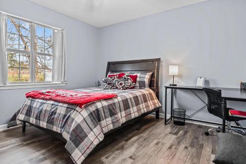 a bedroom with a bed and a desk at Woodstone Retreat Condo right next to UGA golf course! in Athens