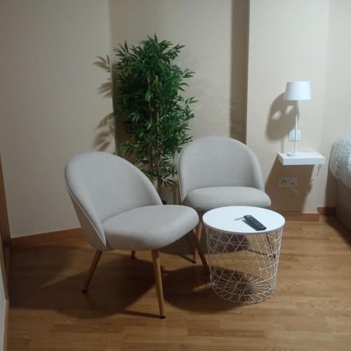 two chairs and a table in a room at A Cabana I in Porriño