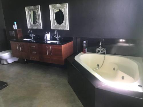 y baño con bañera, lavabo y aseo. en WaTa House in Felixton, en Richards Bay