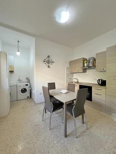 a kitchen with a table and chairs in a room at Wyndcliffe in Anzio