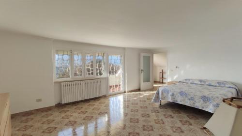 a white bedroom with a bed and a window at Wyndcliffe in Anzio