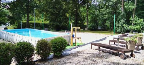 a swimming pool with a playground in a park at Rezydencja Lawendowe Wzgórze in Zachełmie