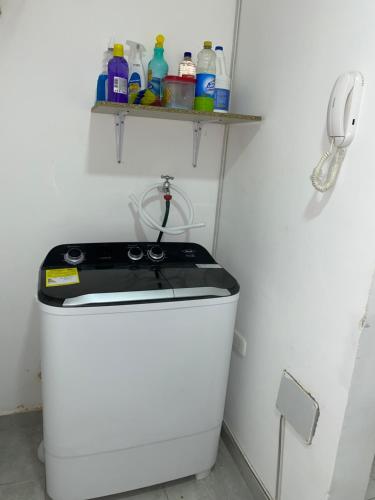 a kitchen with a stove and a phone on a shelf at Apto Boho in Cartagena de Indias
