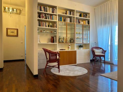 a home office with a desk and bookshelves at Panoramico72 in Ravenna