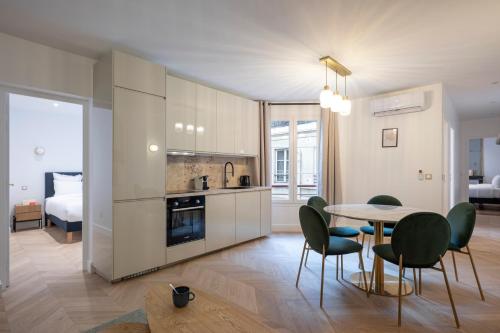 uma cozinha e sala de jantar com mesa e cadeiras em Opera Residence em Paris