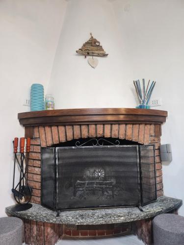a brick fireplace in a living room with at Villa Valentina in Madonna dellʼAcqua