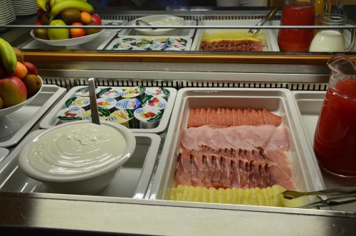 a refrigerator filled with different types of food at Hotel Garnì Carpe Diem in Vigo di Fassa