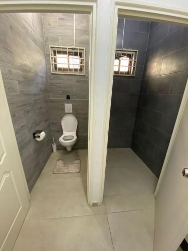 a small bathroom with a toilet in a room at Kappa's place Hendrika veldkampstraat 55A in Paramaribo