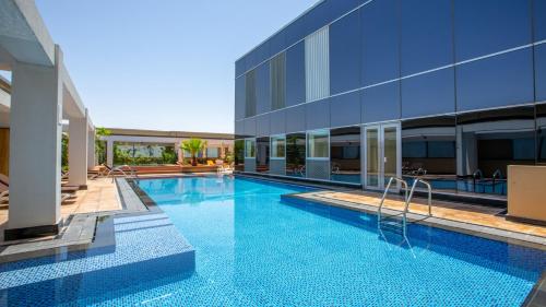 a swimming pool in front of a building at MODERN SPACIOUS STUDIO in PRIME LOCATION Central DIFC & World Trade Centre Dubai at SKY GARDENS in Dubai