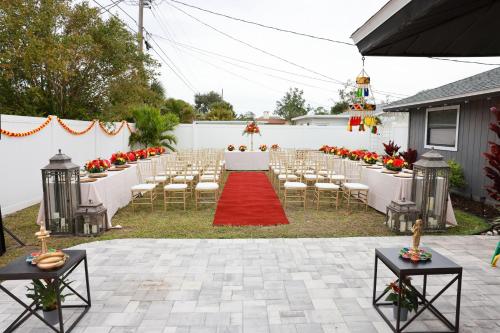 an outdoor ceremony with chairs and a red carpet at Venice 3 Bedroom Luxury Home, Completely Renovated, 5 Star Rated - 10Mins to Beaches in Venice