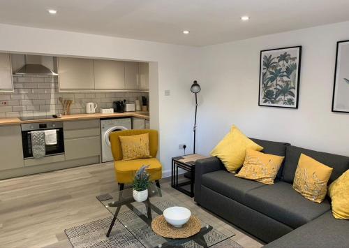 a living room with a couch and a kitchen at The White House By Select SA in Reading