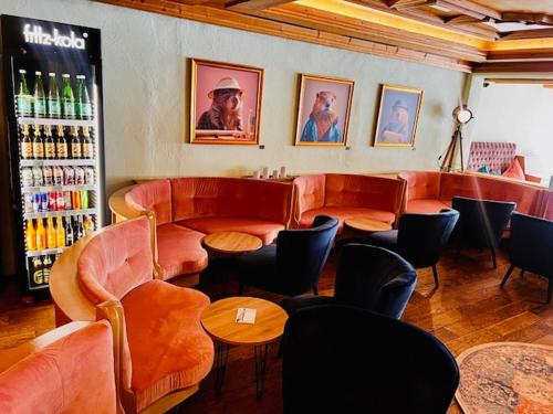 a restaurant with chairs and tables and a bar at Wellness Aparthotel "Lechlife" incl Pool - 400m zum LIFT in Reutte
