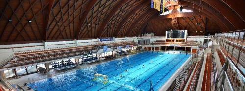 a large swimming pool in a large building at Albina apartman in Eger