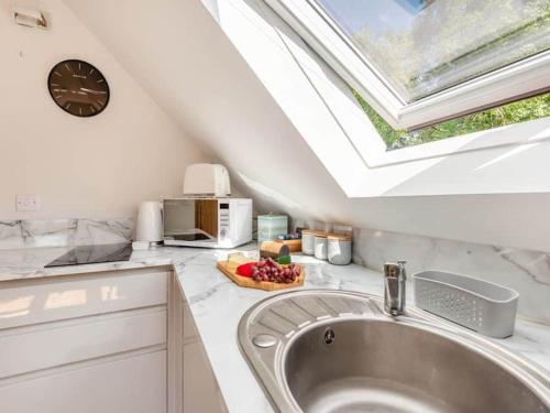 a kitchen with a sink and a skylight at Three Gables in Kirklington