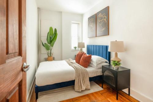 a bedroom with a bed and a table with a cactus at 61-2C Prime UES 2BR Newly furnished best value in New York