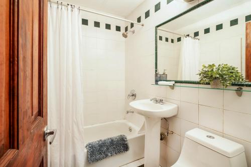 a white bathroom with a sink and a toilet at 61-2C Prime UES 2BR Newly furnished best value in New York