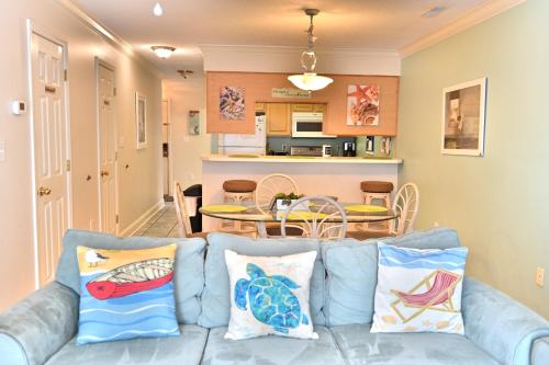 a living room with a blue couch with pillows at Spacious Home by the Beach 2# in Myrtle Beach