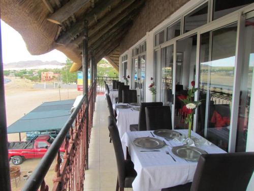 a row of tables on the balcony of a restaurant at Ochsenwagen Pension Hotel in Rehoboth