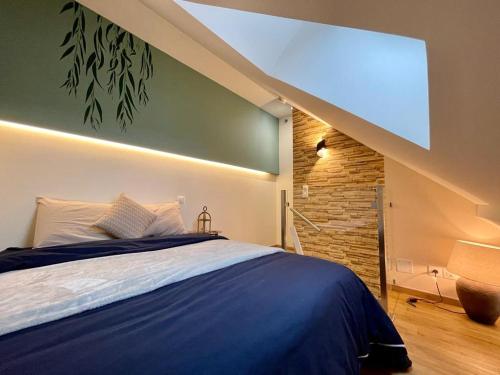 a bedroom with a bed and a large window at Studio cosy in Oye-et-Pallet