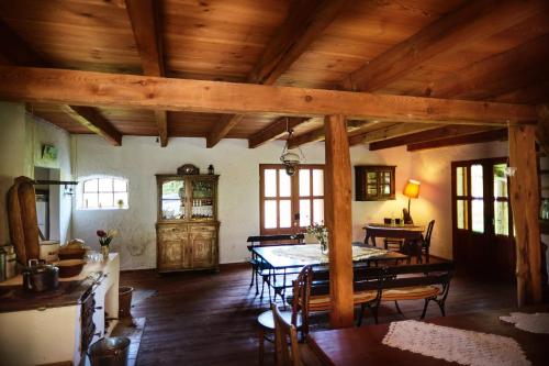 comedor con mesa y sillas y techos de madera en Siedlisko pod dębem Kalnik, en Kalnik