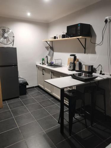 a kitchen with a table and a counter top at Ruach 5 in Bellville