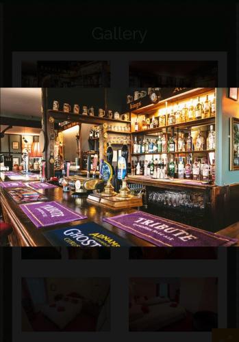 a bar with a lot of bottles of alcohol at Kings Arms Hotel in Sandwich