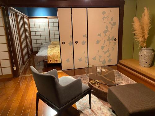 a living room with a chair and a bedroom at Shikoku no minami - Vacation STAY 49277v in Shishikui