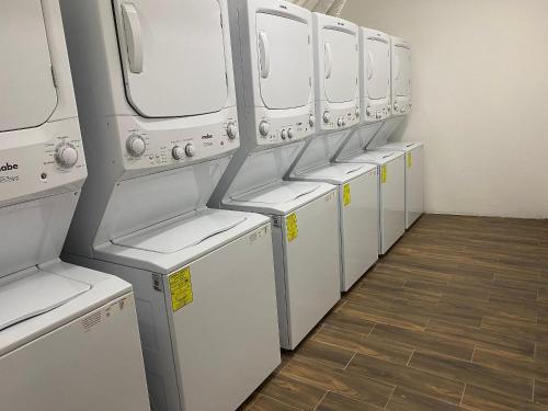 a row of white washers and dryers in a room at Refugio del Mar Luxury Hotel Boutique in Bucerías