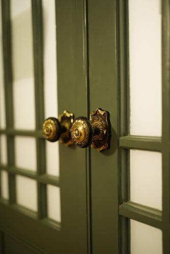 a green door with a brass door knob at Art Apartment Bydgoszcz in Bydgoszcz