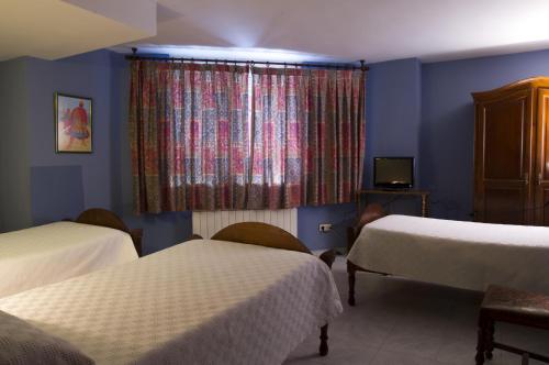 Un pat sau paturi într-o cameră la Hostal Algodon